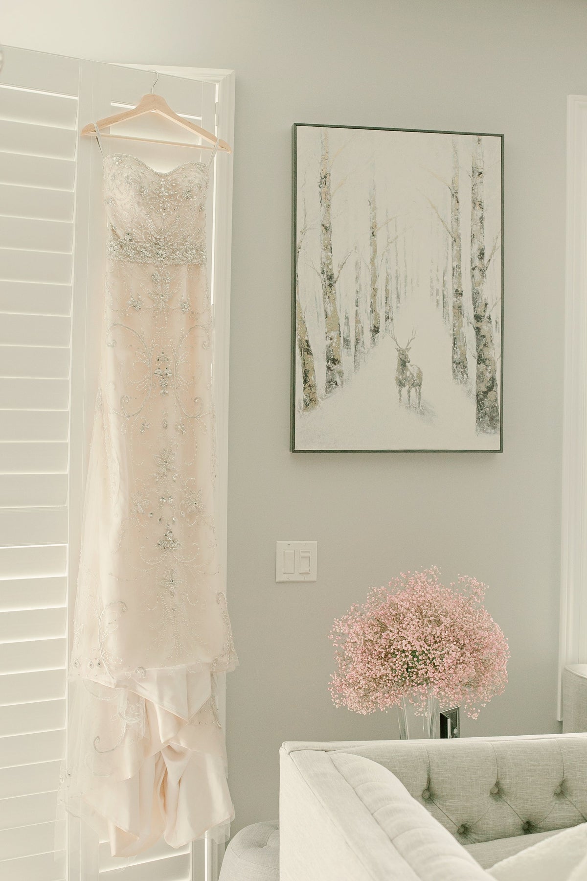 Embroidered gown hanging in a light-filled roomslide_2
